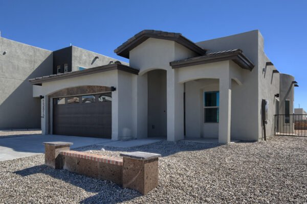 Front exterior of a modern stucco home with garage