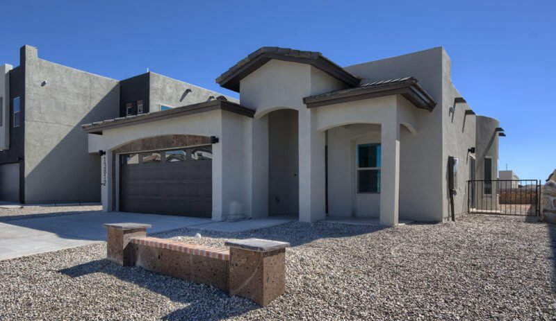 Front exterior of a modern stucco home with garage