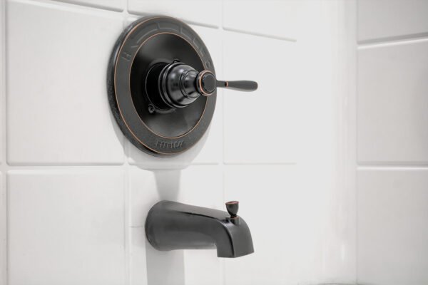 Close‑up of bathroom sink faucet fixtures on vanity