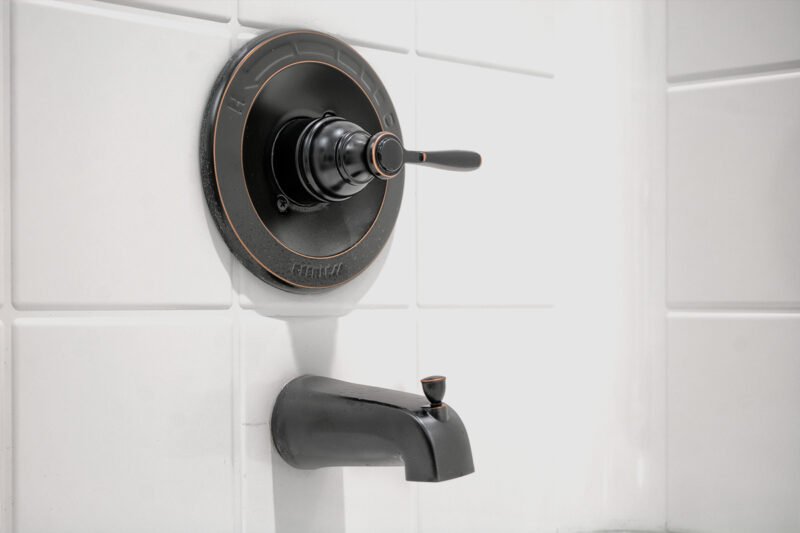 Close‑up of bathroom sink faucet fixtures on vanity