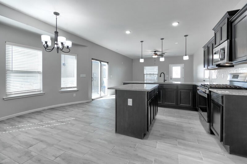 Kitchen and dining area with island and chandelier