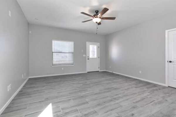 Living room with windows, carpet, and ceiling fan