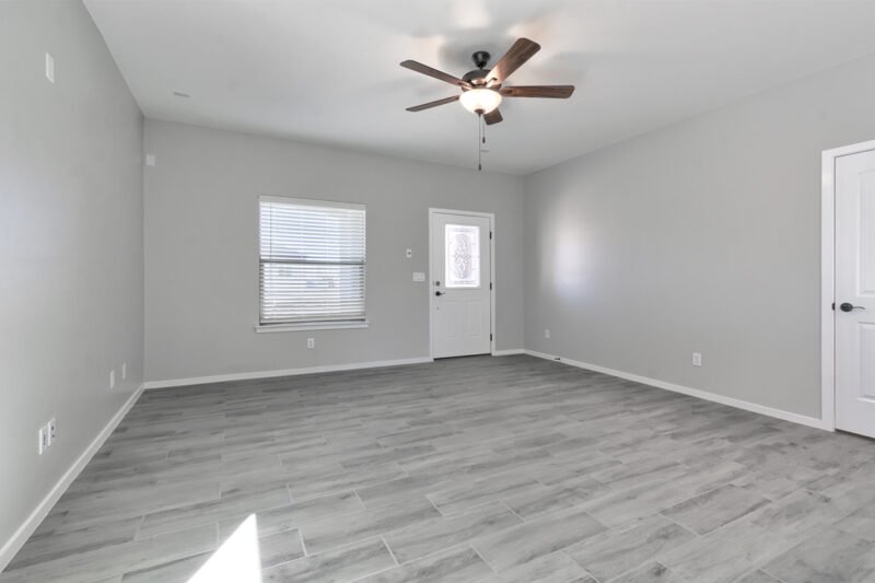 Living room with windows, carpet, and ceiling fan