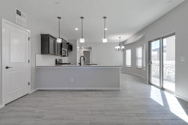 Open plan living room and kitchen with island and sliding glass door