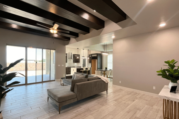 ving room with sofa and wooden beams.