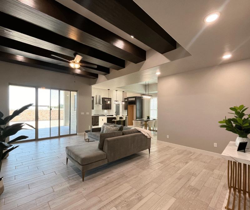 ving room with sofa and wooden beams.