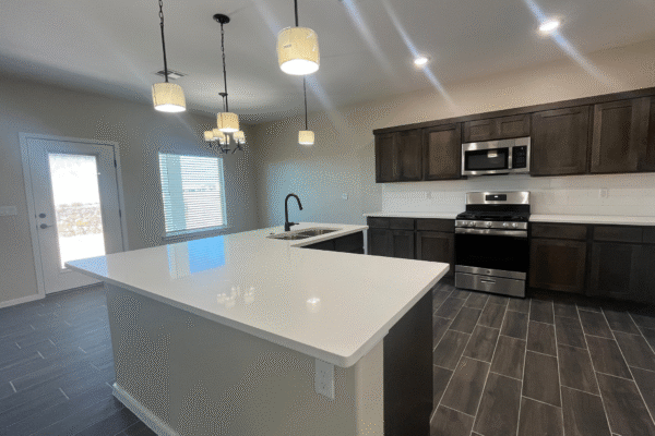 Kitchen with large island and stainless steel stove