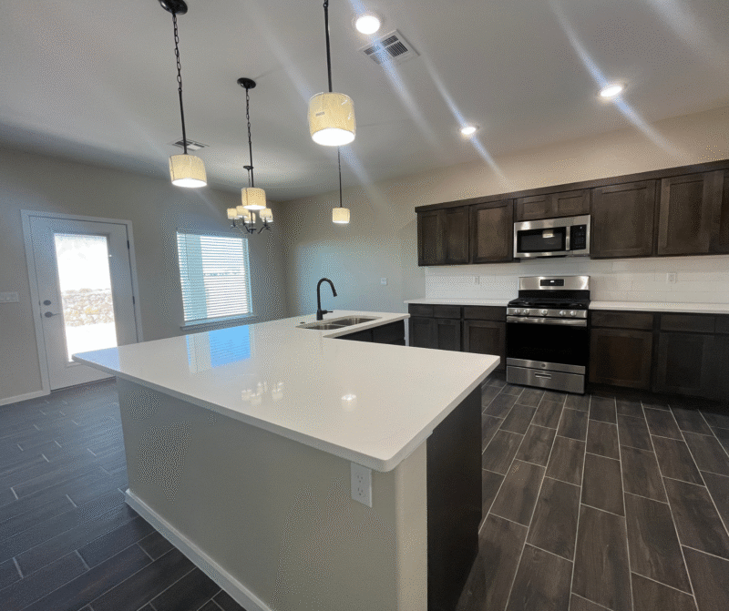 Kitchen with large island and stainless steel stove