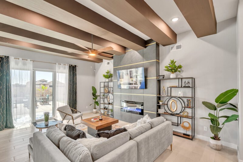 Stylish living room with sofa, fireplace wall, and sliding patio doors