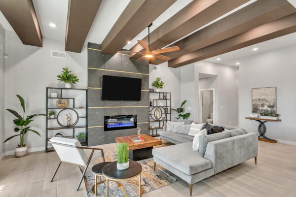 Stylish living room with sectional sofa, modern fireplace wall and ceiling beams