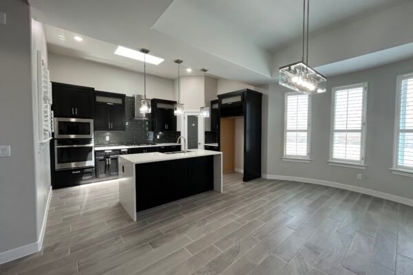 Open kitchen and dining area with island and pendant lights