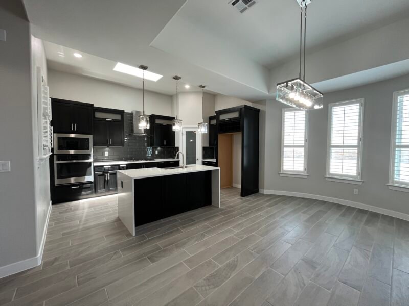 Open kitchen and dining area with island and pendant lights