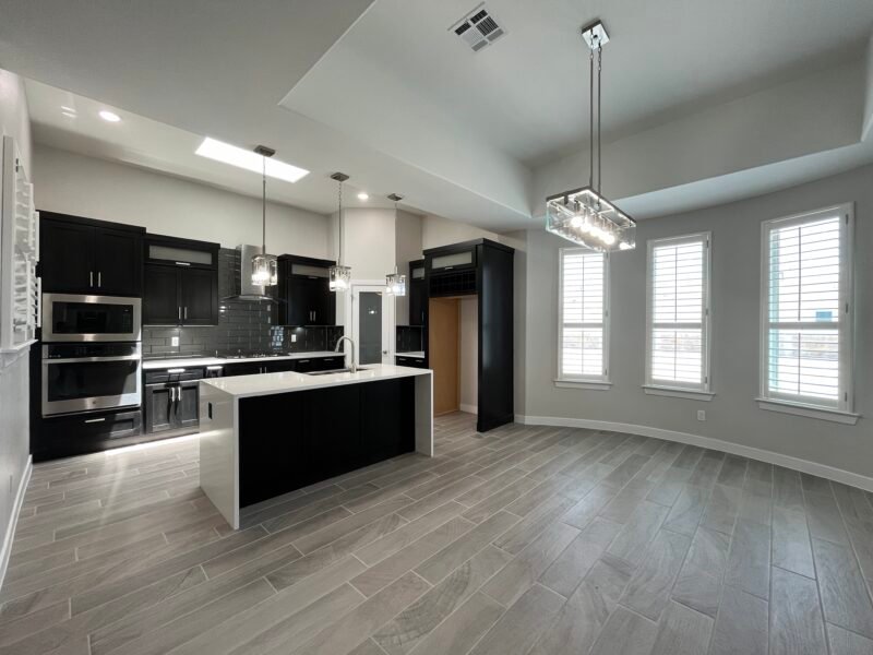 Cornor View Open kitchen and dining area with island and pendant lights