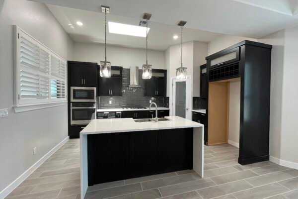 Kitchen with island, dark cabinets, and hanging lights