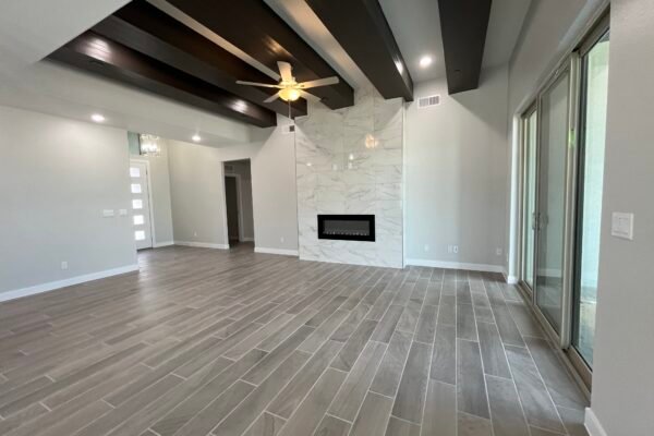 Living room with high ceiling beams and fireplace