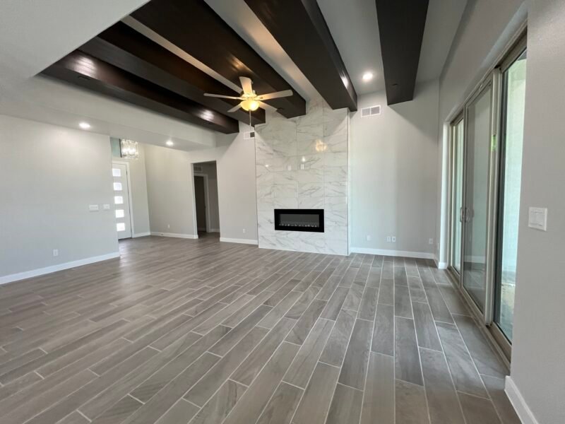 Living room with high ceiling beams and fireplace