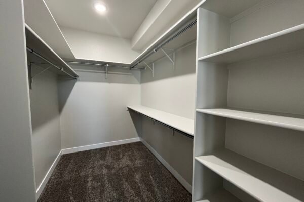 Walk‑in closet with shelves and hanging rods