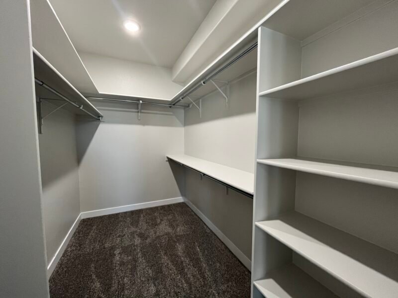 Walk‑in closet with shelves and hanging rods