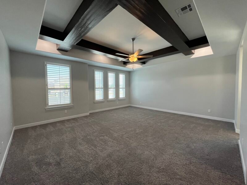 bedroom with ceiling beams and fan