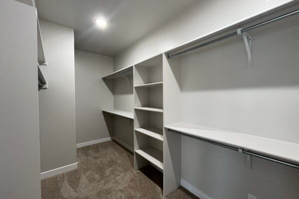 Spacious walk‑in closet with built-in shelves and hanging rods