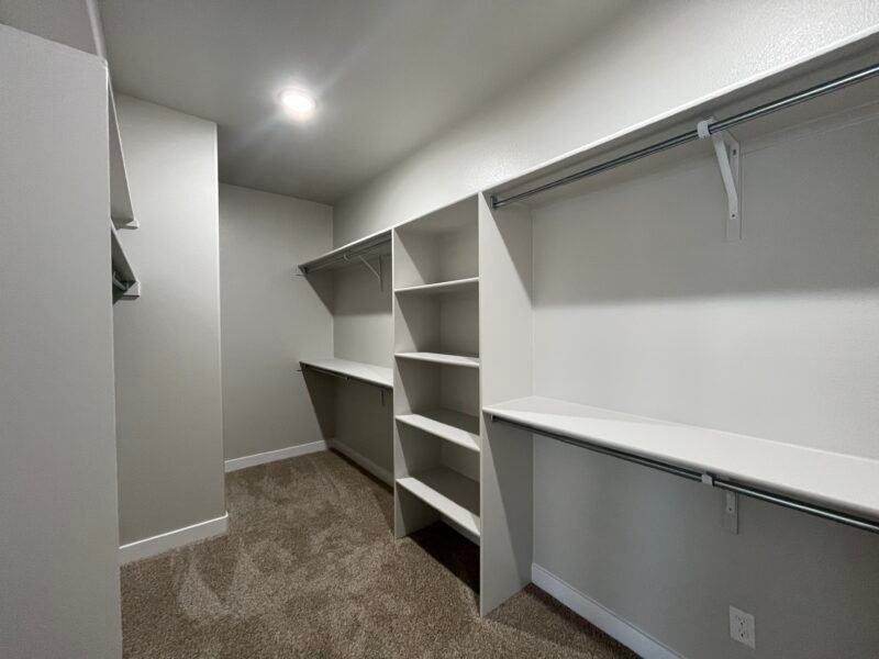 Spacious walk‑in closet with built-in shelves and hanging rods