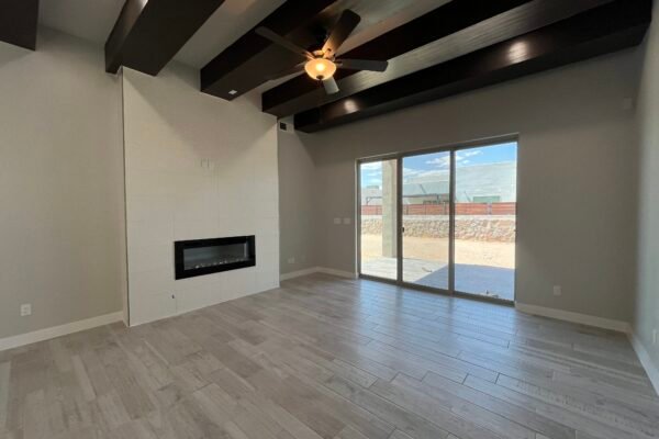 Living room with wood‑look tile floor and ceiling fan