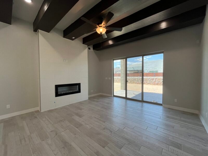 Living room with wood‑look tile floor and ceiling fan