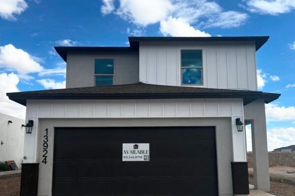 Front exterior of a new modern two‑story home with garage
