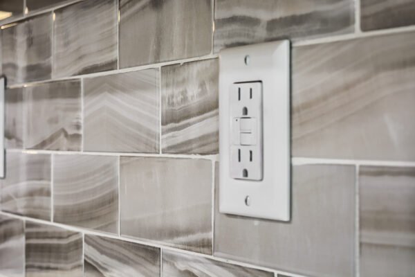 kitchen backsplash tile pattern with a white electrical outlet
