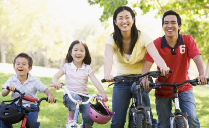 Family riding bikes outside