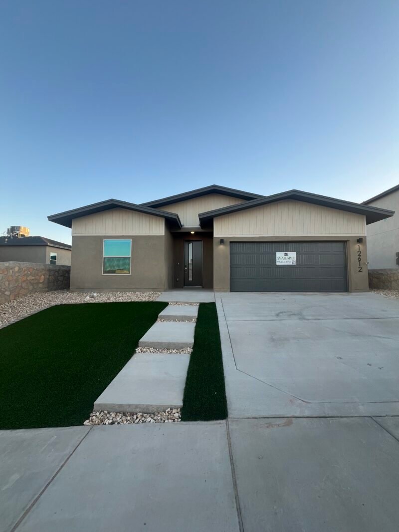 A top-down view of a single-story home showing the roof, and surrounding yard