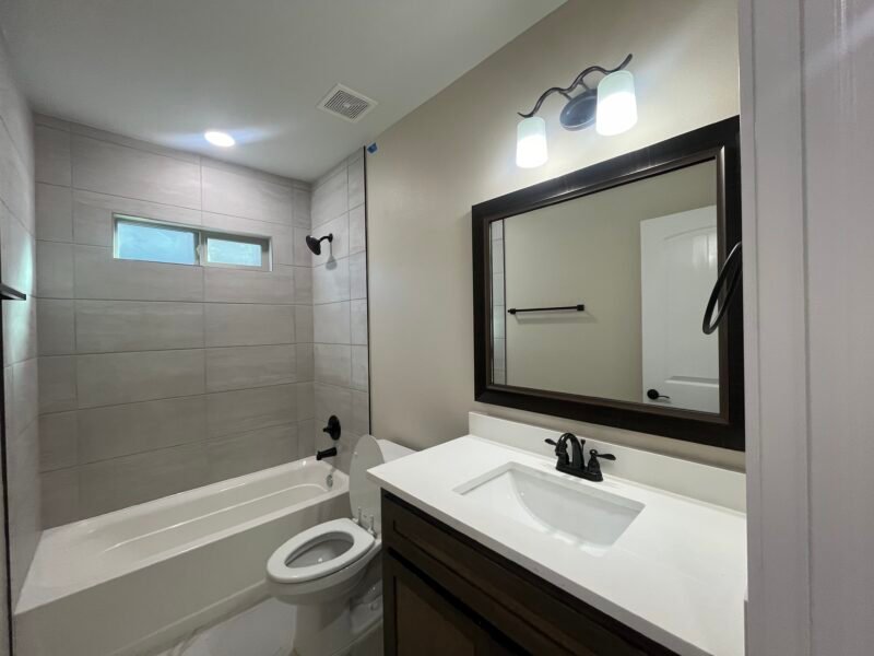 Bathroom interior with vanity, mirror, and tub