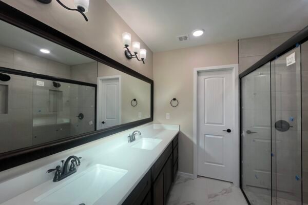 Bathroom with double sink vanity and glass shower