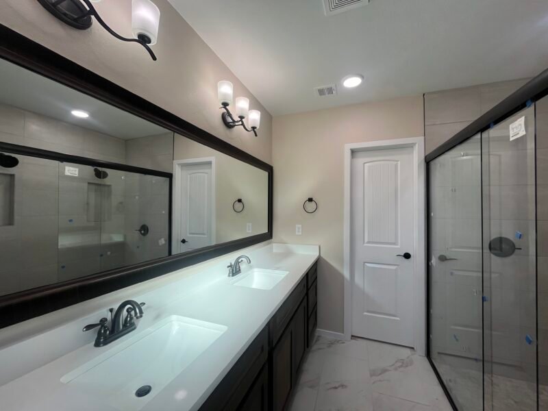 Bathroom with double sink vanity and glass shower