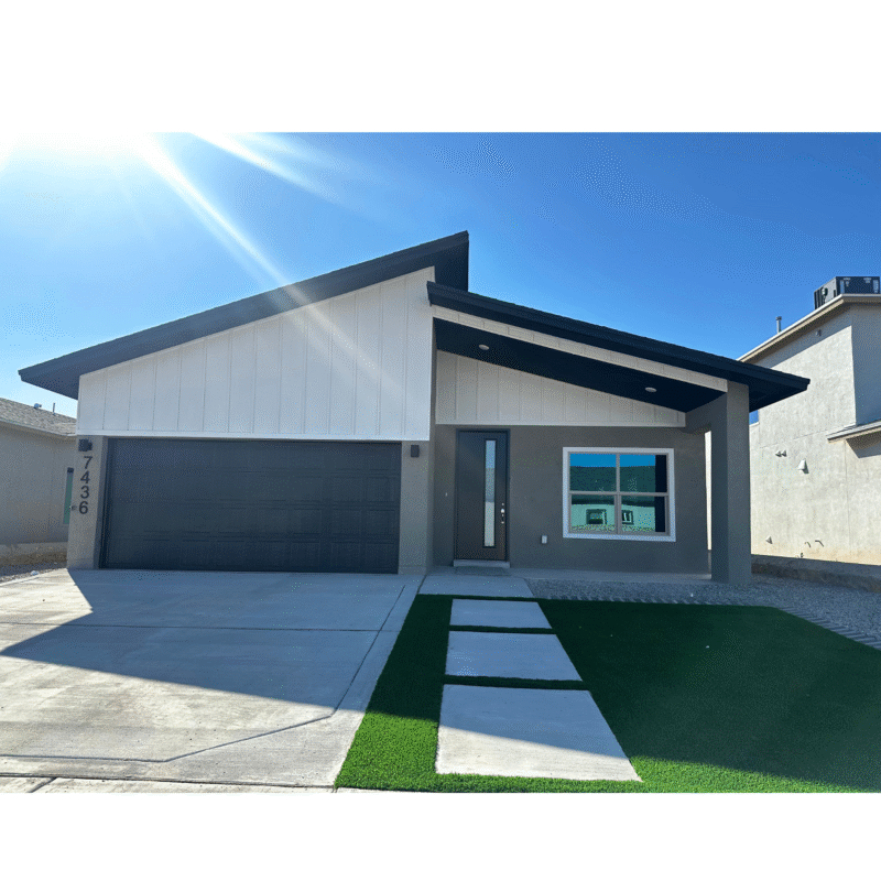 Modern single‑story home exterior with sloped roof and driveway